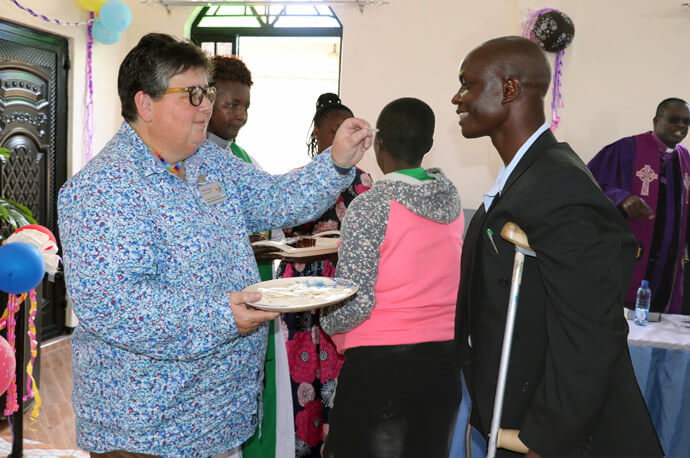 Helen Ryde, Reconciling Ministries Network organizer and a member of the United Methodist Queer Delegate Caucus, serves Holy Communion at First United Methodist Church Moheto during the dedication of the church’s sanctuary in the Nyanza District of Kenya in 2022. File photo by Gad Maiga, UM News.