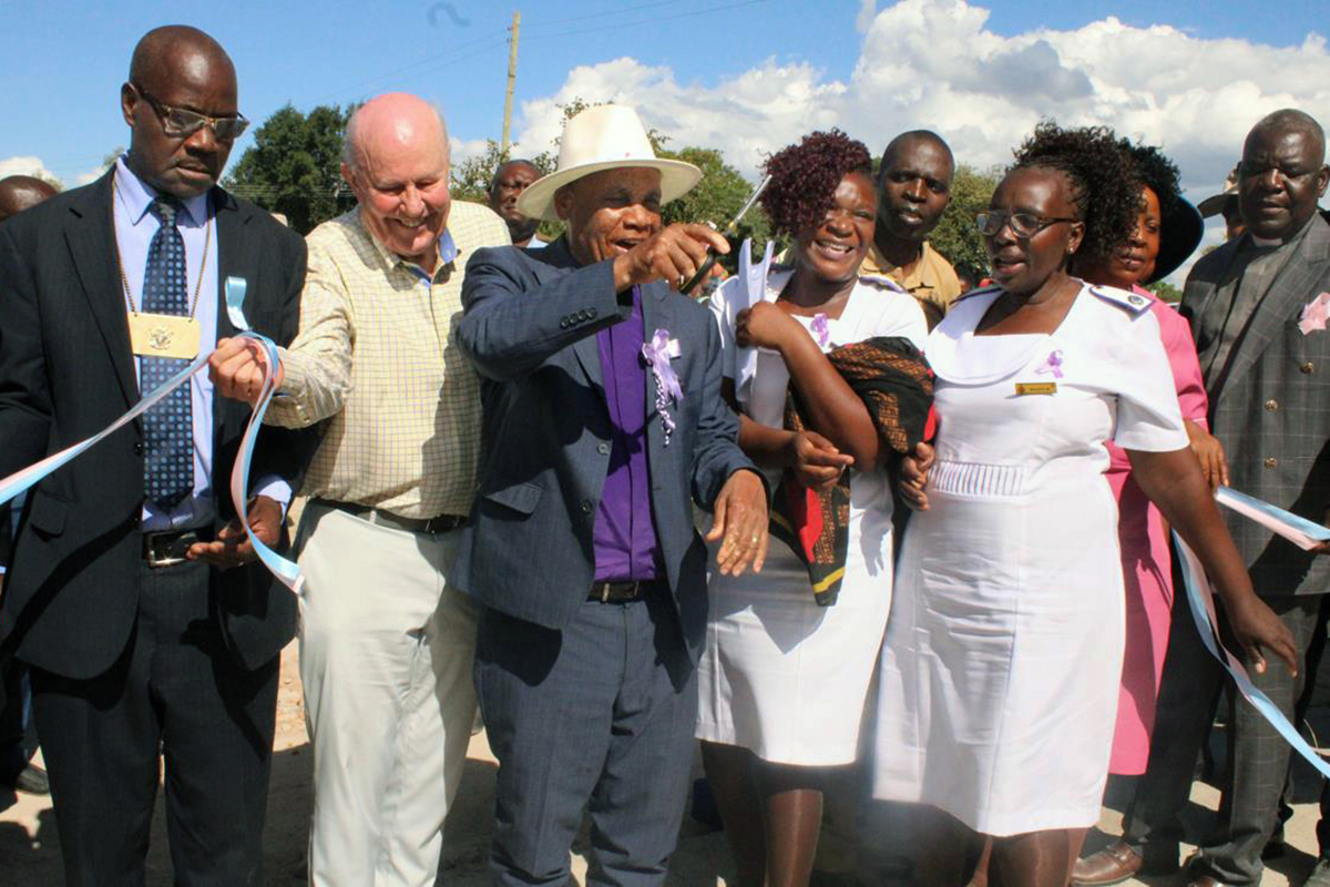 United Methodist Bishop Eben K. Nhiwatiwa (center) cuts the ribbon at the dedication of the new Munyarari Mission Clinic in Munyarari, Zimbabwe, on Feb. 24. The state-of-the-art facility was constructed with funds raised by Bel Air United Methodist Church in Bel Air, Md., and its mission team, Chabadza-Healing Hands Across Zimbabwe, in partnership with the local community. To the bishop’s right is David Talbot, a team leader from Bel Air United Methodist Church. Photo by Kudzai Chingwe, UM News.