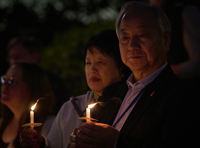 Bishop Hee-Soo Jung of the Wisconsin Annual Conference, who is also president of the board of directors of the United Methodist Board of Global Ministries, holds a candle at the Vigil for Creation on April 22 to call the denomination to greater stewardship of creation. His wife, the Rev. Im Hyon Jung, stands beside him. She is an elder in the Wisconsin Conference and director of International Relations, Asia & Global Programs, for the Upper Room/Discipleship Ministries. The service took place at the First United Methodist Church of Charlotte. Photo by Paul Jeffrey, UM News.