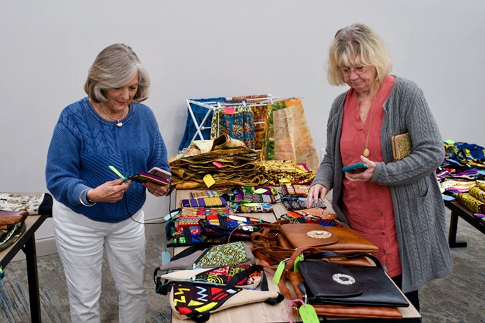 United Women in Faith volunteers from the Western North Carolina Conference help to sort and organize crafts brought by central conference delegates to the postponed 2020 United Methodist General Conference in Charlotte, N.C. The goods are for sale at the Worldwide Craft Market, which is open at the Hilton Garden Inn, a block from the Charlotte Convention Center, daily except Sunday. Photo by Patrick Scriven, Pacific Northwest Conference for the Western Jurisdiction. 
