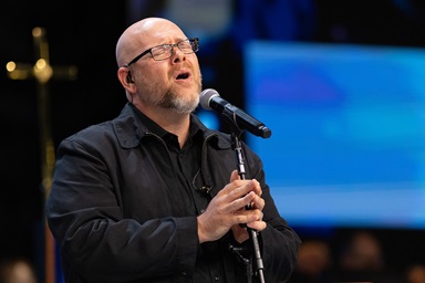 The Rev. Matt Rawle sings during morning worship at the United Methodist General Conference in Charlotte, N.C. Rawle is a Louisiana Conference delegate at the conference but also is on stage during morning worship, singing with the band. Photo by Mike DuBose, UM News.