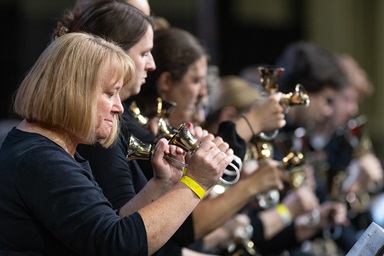 Members of the Charlotte Bronze Handbell Ensemble play during morning worship during the 2024 United Methodist General Conference in Charlotte, N.C. Photo by Mike DuBose, UM News.