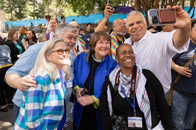 Mark Miller (right) takes a group photo outside the  United Methodist General Conference in Charlotte, N.C., with people celebrating The United Methodist Church’s removal of its ban on the ordination of clergy who are “self-avowed practicing homosexuals” — a prohibition that dates to 1984. At center is Bishop Karen Oliveto, the denomination’s first openly gay bishop. Her wife, Robin Ridenour, is at left. Photo by Mike DuBose, UM News.