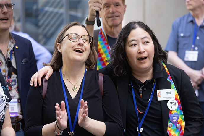Amanda Mountain (left) and Bridget Cabrera celebrate outside the Charlotte Convention Center during the United Methodist General Conference in Charlotte, N.C., after delegates eliminated the longtime assertion in the denomination’s Social Principles that “the practice of homosexuality… is incompatible with Christian teaching.” Photo by Mike DuBose, UM News.