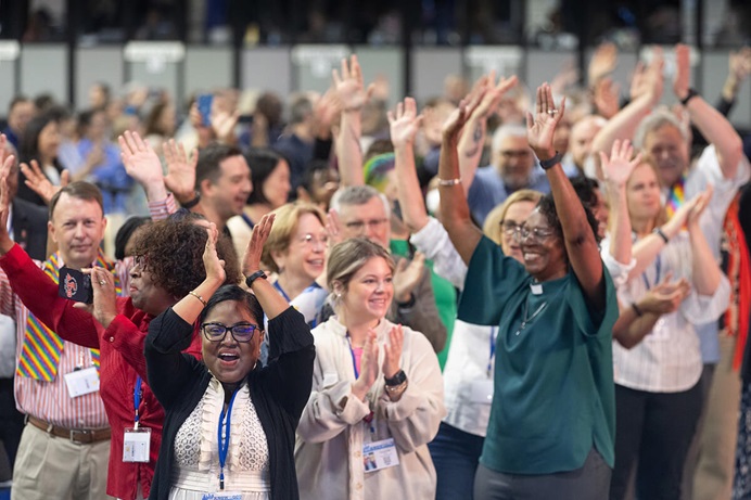 Delegates, visitors and staff of the United Methodist General Conference in Charlotte, N.C., dance in the aisles following morning worship on the final day of the conference. Photo by Mike DuBose, UM News.
