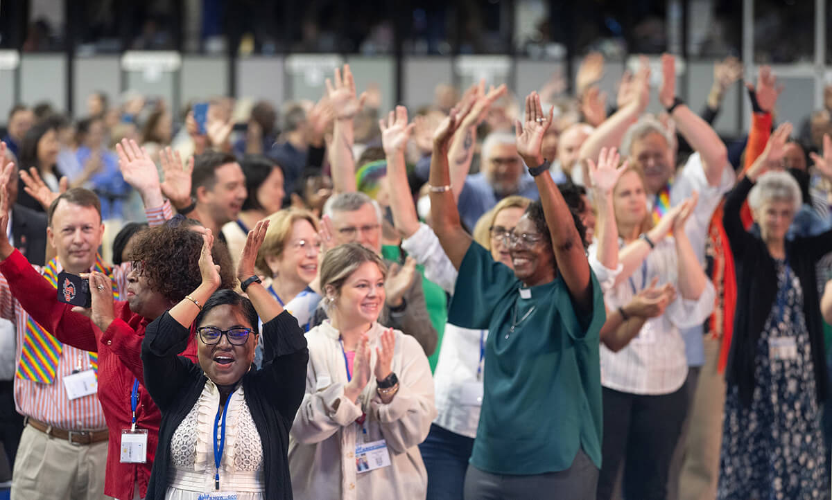 Delegates, visitors and staff of the United Methodist General Conference in Charlotte, N.C., dance in the aisles following morning worship on the final day of the conference. Photo by Mike DuBose, UM News.