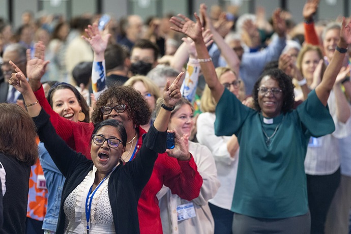 Delegates, visitors and staff of the United Methodist General Conference in Charlotte, N.C., dance in the aisles following morning worship on the final day of the conference. Delegates to the 10-day legislative assembly supported big changes, including the removal of constraints on ministry with and by LGBTQ people. Photo by Mike DuBose, UM News.
