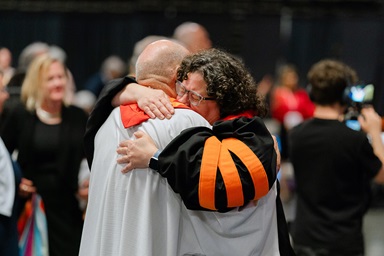 The Rev. Beth Stroud (right) hugs Bishop John Schol after she was reinstated as clergy on May 21 during a closed clergy session of the Eastern Pennsylvania Annual Conference in Wildwood, N.J. Stroud was defrocked 20 years ago after admitting to being in a committed relationship with another woman. Photo by Shari DeAngelo, courtesy of the Eastern Pennsylvania Conference. 