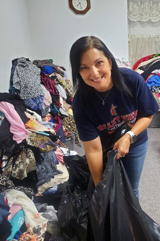 Tracie Shelburne, a member of Valley View United Methodist Church in Valley View, Texas, sorts donated items after a tornado struck the area over Memorial Day weekend. Photo by the Rev. Beate Hall.