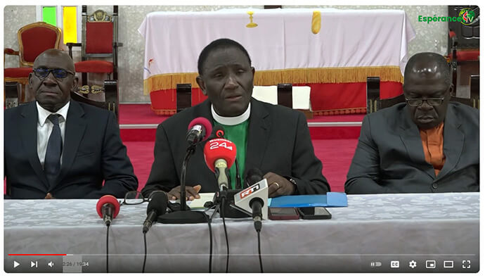 At center, the Rev. Isaac Bodjé, Côte d’Ivoire Conference secretary, reads a statement to local press that explains the Côte d'Ivoire Conference is leaving because of changes made by the recent General Conference. He is accompanied by other conference leaders. Screengrab courtesy of the Côte d'Ivoire Conference via YouTube by UM News. 