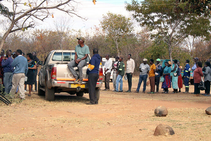 Residents and employees at Nyadire Mission line up to receive food support provided by The Nyadire Connection. The nonprofit raised more than $100,000 to provide food to the Nyadire community through the end of the year. Photo by Kudzai Chingwe, UM News.