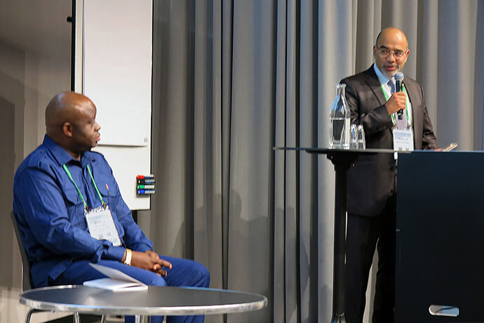 Roland Fernandes (right), top executive of the United Methodist boards of Global Ministries and Higher Education and Ministry, addresses North Katanga Bishop Mande Muyombo. The bishop, who also chairs The United Methodist Church’s Connectional Table, spoke about the concept of regionalization at the International Association of Methodist Schools, Colleges and Universities gathering. Photo by Heather Hahn, UM News.         