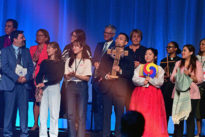 Representatives from each of the Methodist-rooted denominations at the World Methodist Conference stand with a symbol representing their denomination. The World Methodist Conference in Gothenburg, Sweden, brought together more than 1,000 representatives of denominations with Methodist heritage for a time of worship, fellowship and exchanging ideas. Photo by Klaus Ulrich Ruof, Germany Central Conference.