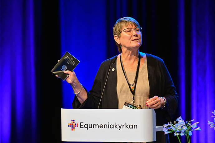 The Rev. Dr. Kimberly Reisman, a United Methodist and executive director of World Methodist Evangelism, presents the Faith-Sharing New Testament with the Psalms. The text also includes basics of the Christian Faith. World Methodist Evangelism is an affiliate of the World Methodist Council, which organized the World Methodist Conference. Photo by Klaus Ulrich Ruof, Germany Central Conference.