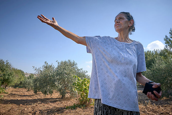 Amal Nassar shows off her family farm near Bethlehem in the Israeli-occupied West Bank. In 1991, the farm was declared state land, and the Nassars began a long and complicated legal struggle to retain possession. Photo by Paul Jeffrey, UM News.