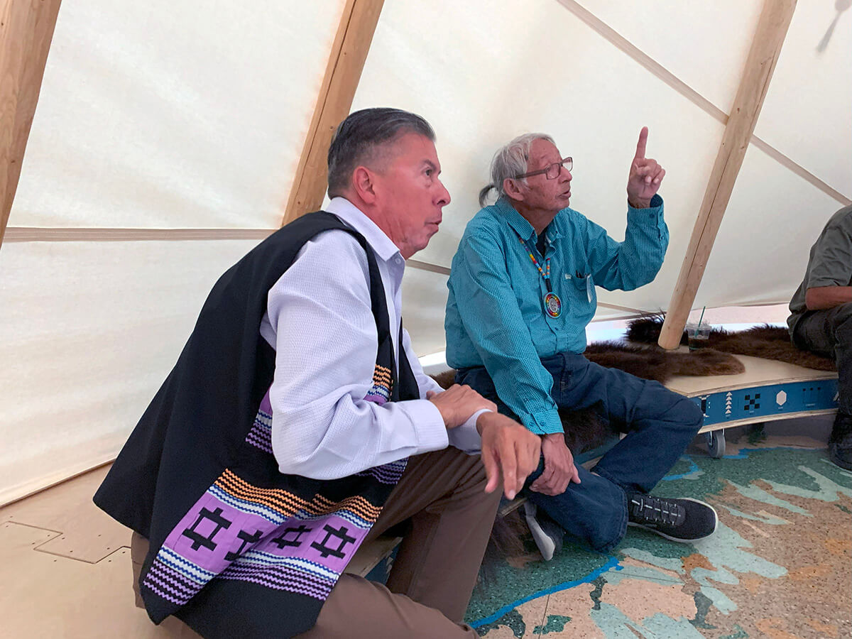 Great Plains Conference Bishop David Wilson, left, and Eugene Ridgely Jr., a Sand Creek representative of the Northern Arapaho tribe, gather in an Arapaho tipi located at the History Colorado Center in Denver. Both men are part of the United Methodist Responses to the Sand Creek Massacre Team, which met Sept. 20-21 at Iliff School of Theology to formulate next steps in the denomination’s work to atone for its role in the 1864 Sand Creek Massacre. Photo by Joey Butler, UM News.
