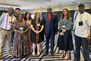 From left, Pacome Nguessan, Matt Crum, Priscilla Muzerengwa, Jennifer Rodia, Ashley Gish, North Katanga Area Bishop Mande Muyombo, Poonam Patodia and Chilima Karima celebrate together at the end of training on regionalization. All but the bishop work for United Methodist Communications. Photo courtesy of United Methodist Communications. 