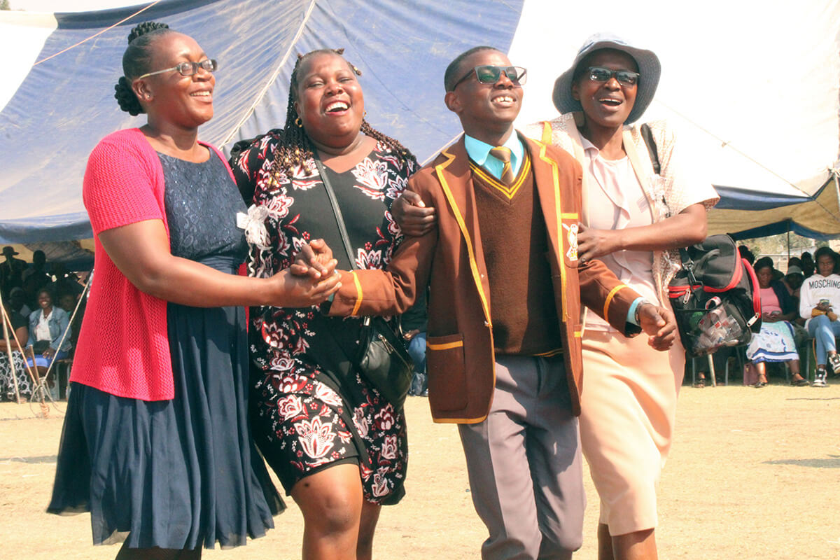 Student Tanaka Chamburuka is surrounded by proud teachers and family after winning the top academic prize for his grade level at Seke 1 High School in Chitungwiza, Zimbabwe. From left are teacher Brenda Chawanji; Sarudzai Chamburuka, Tanaka’s mother; Tanaka; and teacher Rita Gondo. The United Methodist Church in the Chitungwiza Marondera District provided prizes for top students in memory of church member Esnath Ginnah Kadenge, a longtime English teacher at the school. Photo by Kudzai Chingwe, UM News.