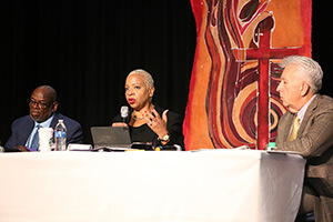 Council of Bishops President Tracy S. Malone (center) addresses the council during its Nov. 3-8 fall meeting. Sitting beside Malone is Bishop L. Jonathan Holston (left), Council of Bishops secretary, and Bishop Ruben Saenz Jr., president-designate. Malone leads the Indiana Conference, Holston leads the North Alabama and Alabama-West Florida conferences, and Saenz leads what will be the Horizon Texas Conference starting Jan. 1. Photo by Rick Wolcott, Council of Bishops. 