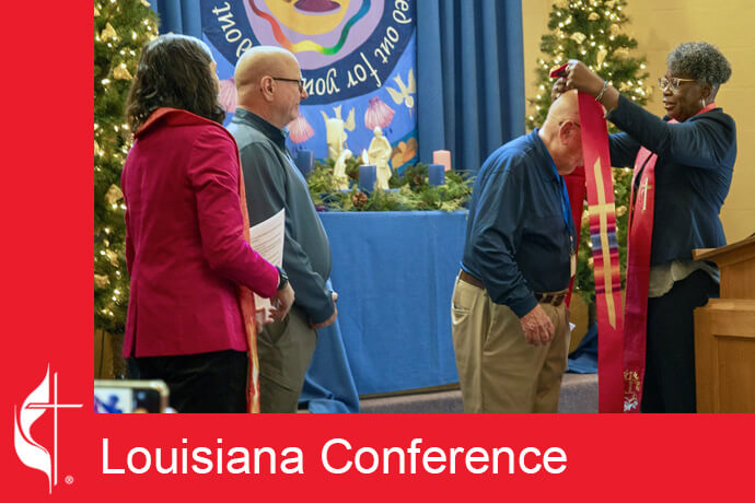 Bishop Delores J. Williamston of the Louisiana Conference places a stole on the shoulders of the Rev. Deen Thompson at Edgehill United Methodist Church in Nashville, Tenn., on Dec. 1. The Rev. Ali Young (far left) of the Louisiana Conference and Thompson's husband, John, also attended. Photo by Susan Ruach, courtesy of the Louisiana Conference.