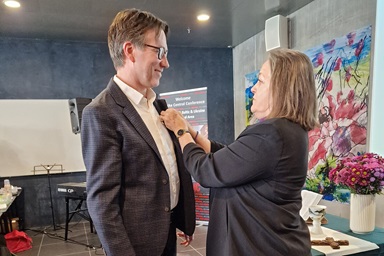The Rev. Knut Refsdal receives the episcopal pin from Bishop Dottie Escobedo-Frank after being elected a United Methodist bishop on April 4 at the Northern Europe and Eurasia Central Conference in Copenhagen, Denmark. Refsdal, a pastor in Norway, was elected on the 26th ballot. Photo by Karl Anders Ellingsen, UM News.  The Rev. Knut Refsdal receives the episcopal pin from Bishop Dottie Escobedo-Frank after being elected a United Methodist bishop on April 4 at the Northern Europe and Eurasia Central Conference in Copenhagen, Denmark. Refsdal, a pastor in Norway, was elected on the 26th ballot. Photo by Karl Anders Ellingsen, UM News.