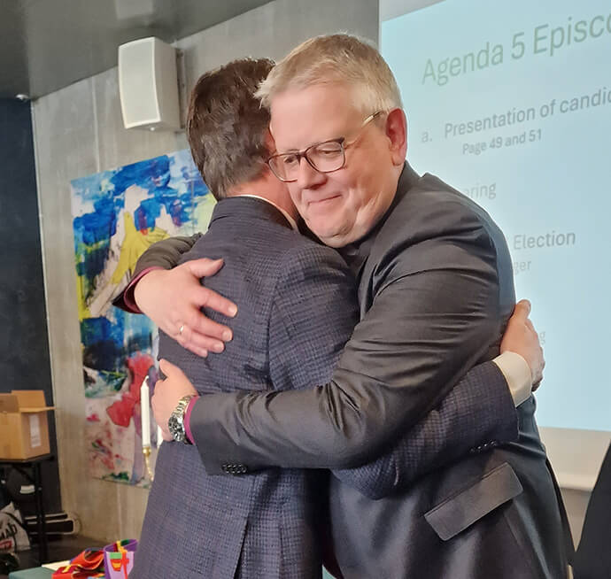 The Rev. Knut Refsdal (left) gets a hug from Bishop Christian Alsted after Refsdal was elected a United Methodist bishop April 4 in Copenhagen, Denmark. Refsdal will lead the Nordic-Baltic-Ukraine Episcopal Area, succeeding Alsted, who is retiring. Photo by Karl Anders Ellingsen, UM News.