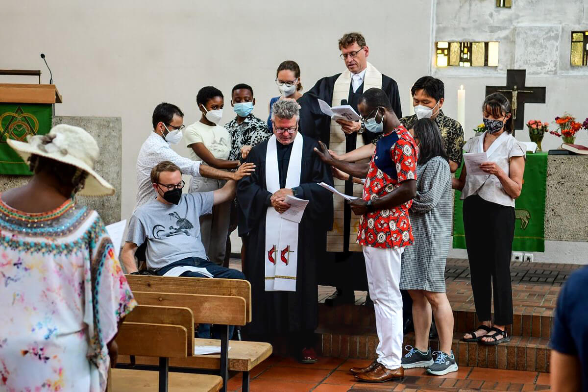 The Rev. Alexander von Wascinski receives a blessing from his congregation at Peace Church United Methodist in Munich, Germany. Photo courtesy of Peace Church United Methodist, via Facebook. Facebook.