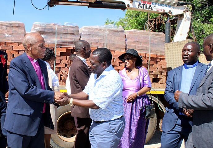Bishop Eben K. Nhiwatiwa thanks Ray Kaukonde for the donation of 40,000 bricks that will be used for the construction of Chikwizo United Methodist Church. Photo by Kudzai Chingwe, UM News.