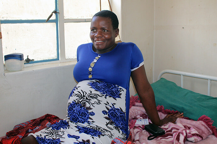 Expectant mother Sarah Master sits at the mother’s waiting shelter at the Chindenga clinic in Mutoko, Zimbabwe. She says she has been pleased with the hospitality and accommodations at the newly renovated clinic. Photo by Kudzai Chingwe, UM News.