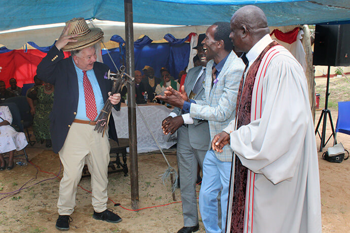 Ralph Duckworth, chair of The Nyadire Connection, dons a souvenir hat that was a gift from the Chindenga community for his efforts with the revitalization of Nyadire Mission Hospital’s rural health clinics in Zimbabwe, a project valued at more than $1.7 million. Duckworth attended the dedication of Chindenga health center on Feb. 22. Photo by Kudzai Chingwe, UM News.