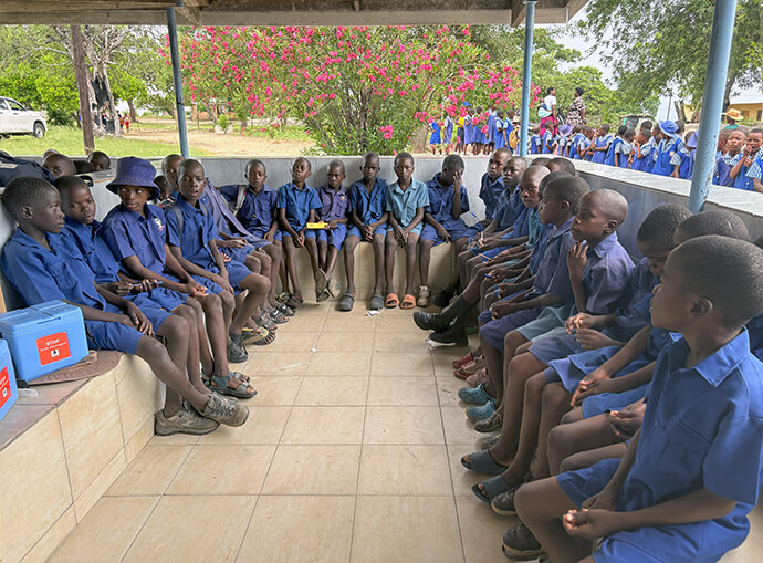 Schoolchildren from the United Methodist Chikwizo Primary School await their turn to get polio vaccines at Chikwizo rural health clinic in February. Polio is a killer disease affecting children under 10 years old. According to the World Health Organization, Zimbabwe is part of the Global Polio Eradication Initiative and has sustained high vaccination coverage with over 90% of children receiving vaccines. Photo by Eveline Chikwanah, UM News.