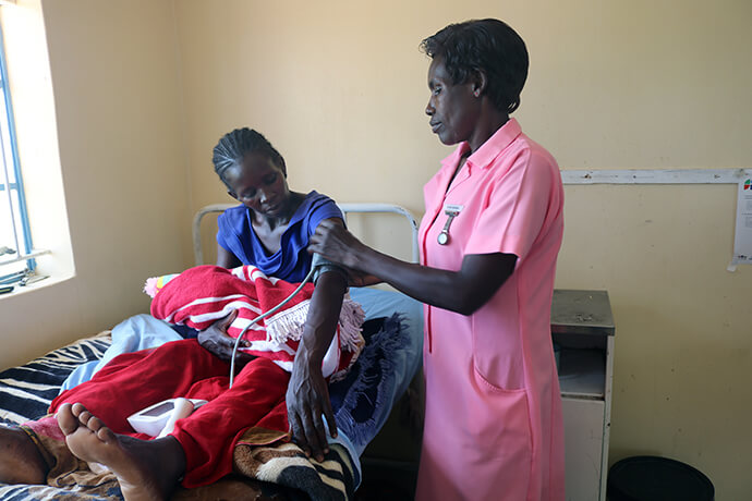 Esther Munhenga checks the blood pressure and other vitals of Loveness Bhobho, 34, about an hour after she delivered her baby at The United Methodist Church’s Mashambanhaka health clinic, which is located about 75 miles from Harare, Zimbabwe. This is Bhobho’s fourth baby and the second to be delivered at the clinic, one of six rural health clinics revitalized by United Methodist partners, including The Nyadire Connection and Global Ministries. Photo by Eveline Chikwanah, UM News.