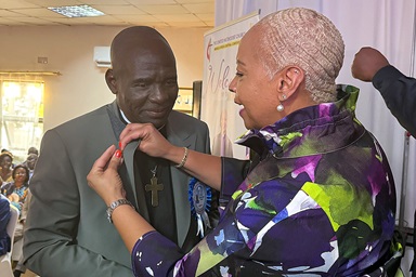 The Rev. Antoine Kalema Tambwe receives the United Methodist episcopal pin from Council of Bishops President Tracy S. Malone after his election on July 12 during the Mid Africa Central Conference in Kitwe, Zambia. The longtime district superintendent is the first of three bishops to be elected at the conference, formerly the Congo Central Conference. Photo by Priscilla Muzerengwa, United Methodist Communications.  The Rev. Antoine Kalema Tambwe receives the United Methodist episcopal pin from Council of Bishops President Tracy S. Malone after his election on July 12 during the Mid Africa Central Conference in Kitwe, Zambia. The longtime district superintendent is the first of three bishops to be elected at the conference, formerly the Congo Central Conference. Photo by Priscilla Muzerengwa, United Methodist Communications.