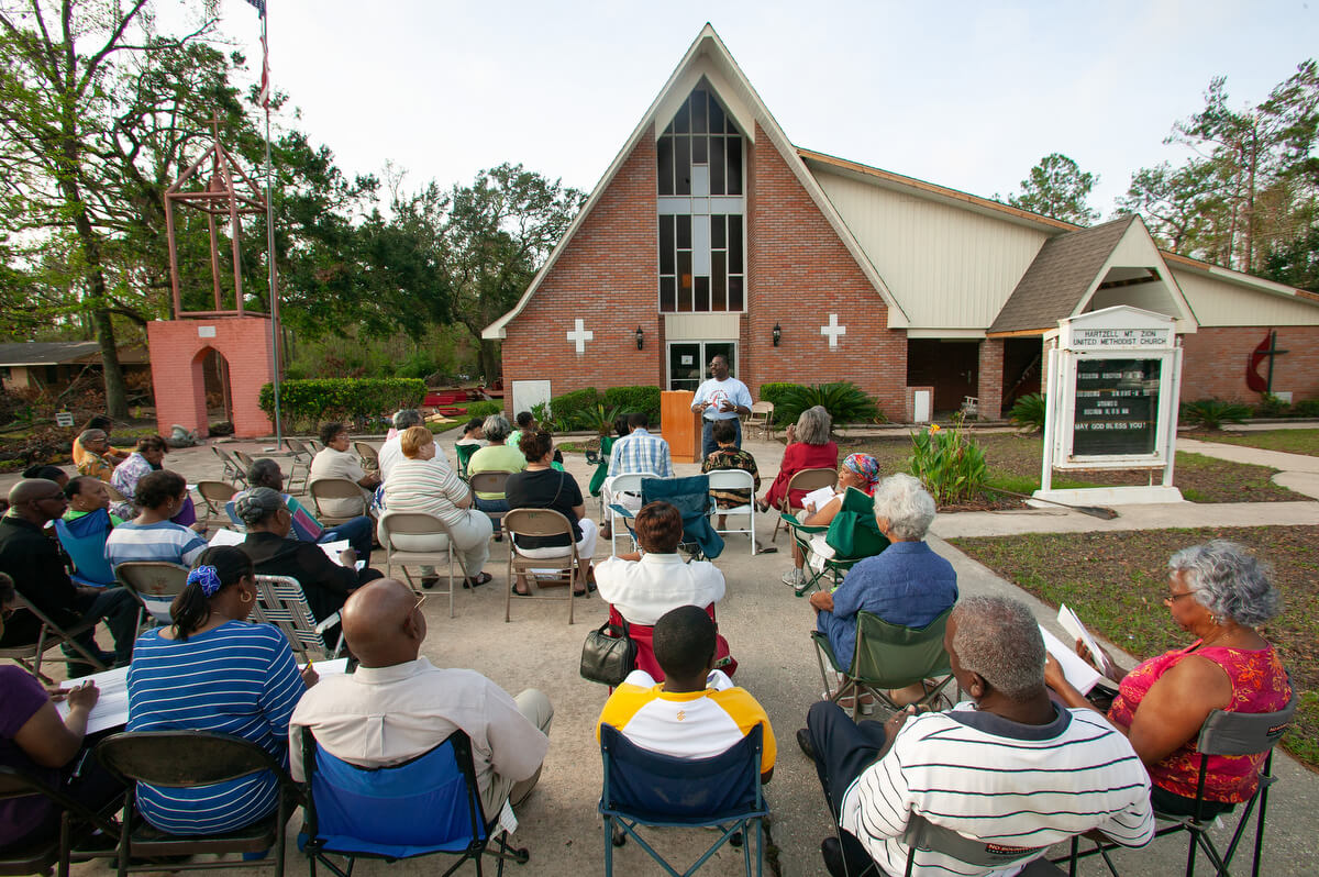 Members of Hartzell Mt. Zion United Methodist Church gather for an outdoor worship service following Hurricane Katrina. The church’s sanctuary was ruined by the storm surge from the hurricane.