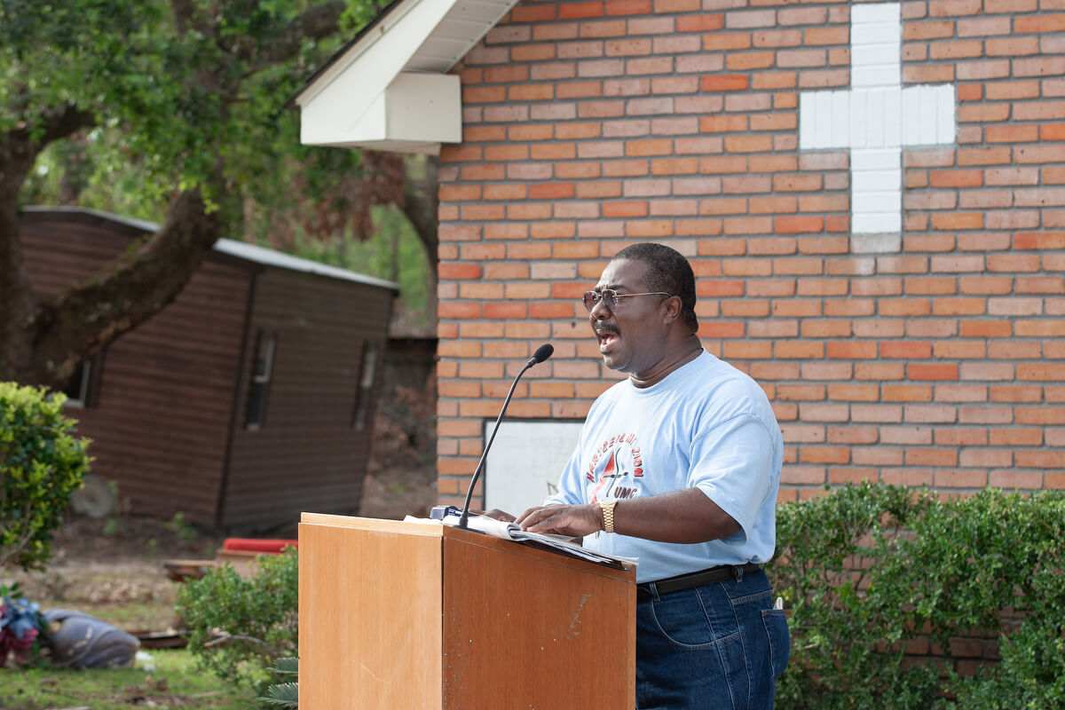 The Rev. Ernest Scott leads an outdoor worship service at Hartzell Mt. Zion United Methodist Church in 2005.