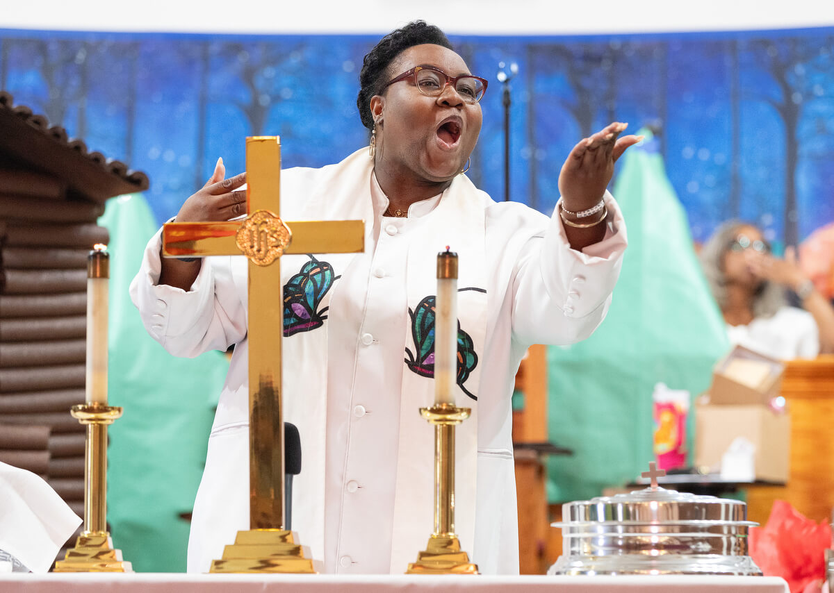 The Rev. Tiffanie Postell blows a kiss to parishioners as she prepares to bless the elements of Holy Communion at Hartzell Mt. Zion United Methodist Church on June 1.
