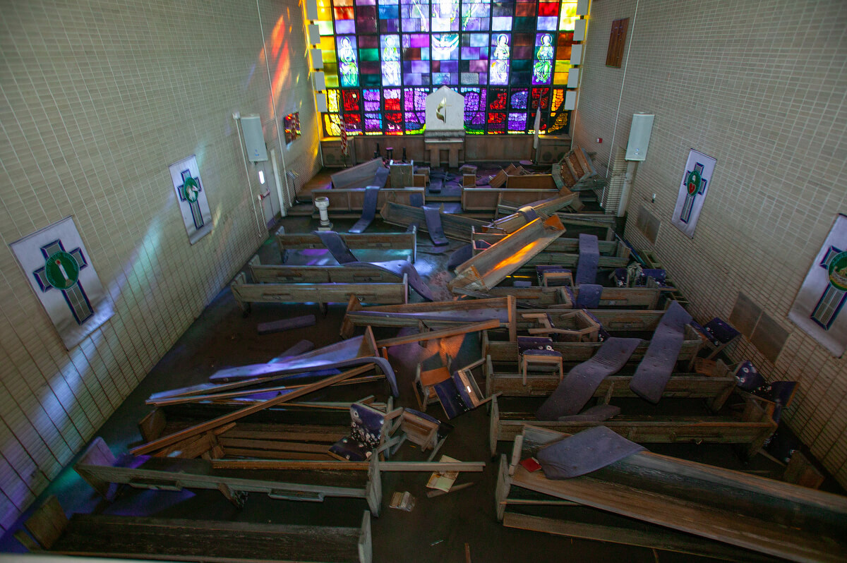 Moldy pews, cushions and chairs are strewn about the sanctuary at St. Luke’s United Methodist Church one month after Hurricane Katrina. Photo by Mike DuBose, UM News.