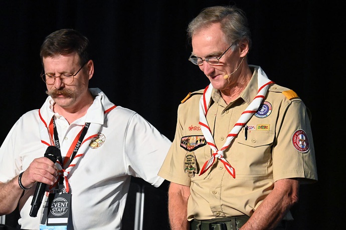 Steven Scheid (left), director of scouting ministry for United Methodist Men, bows his head in prayer Aug. 2 before introducing Roger Krone (right), CEO of Scouting America. Krone spoke Aug. 2 about scouting during the 2025 National Men’s and Scouting Ministry Gathering at Epworth-by-the-Sea, a United Methodist retreat center in St. Simons Island, Ga. Photo by Jim Patterson, UM News. Steven Scheid (left), director of scouting ministry for United Methodist Men, bows his head in prayer Aug. 2 before introducing Roger Krone (right), CEO of Scouting America. Krone spoke Aug. 2 about scouting during the 2025 National Men’s and Scouting Ministry Gathering at Epworth-by-the-Sea, a United Methodist retreat center in St. Simons Island, Ga. Photo by Jim Patterson, UM News.