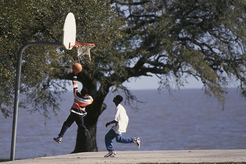 Children play basketball against the backdrop of the Gulf of Mexico at Gulfside Assembly in Waveland, Miss., in 1997. A multicultural conference, retreat and training center, Gulfside provided a meeting place for African-American church leaders in the South. Photo by Mike DuBose, UM News.