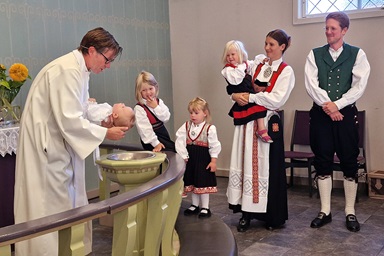 Bishop Knut Refsdal, who leads the Nordic-Baltic-Ukraine Area, baptizes Aksel, as the baby’s parents, Håkon and Astri Helen Madland, look on. The newly elected bishop chose Flekkefjord, Norway, as his first visit in a strong sign of solidarity with the United Methodists there. Photo by Karl Anders Ellingsen, UM News.  Bishop Knut Refsdal, who leads the Nordic-Baltic-Ukraine Area, baptizes Aksel, as the baby’s parents, Håkon and Astri Helen Madland, look on. The newly elected bishop chose Flekkefjord, Norway, as his first visit in a strong sign of solidarity with the United Methodists there. Photo by Karl Anders Ellingsen, UM News.