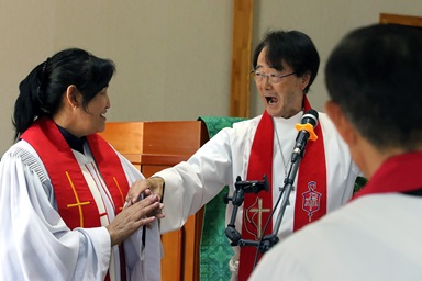 Bishop Jeremiah J. Park (right) congratulates the Rev. R. Jargaltsetseg during the ordination service at the United Methodist Mongolia Mission Initiative’s annual meeting, held at Gerelt United Methodist Church in Ulaanbaatar, Mongolia, on Aug. 30. Jargaltsetseg was ordained as a mission elder. Photo by the Rev. Thomas E. Kim, UM News. Bishop Jeremiah J. Park (right) congratulates the Rev. R. Jargaltsetseg during the ordination service at the United Methodist Mongolia Mission Initiative’s annual meeting, held at Gerelt United Methodist Church in Ulaanbaatar, Mongolia, on Aug. 30. Jargaltsetseg was ordained as a mission elder. Photo by the Rev. Thomas E. Kim, UM News.