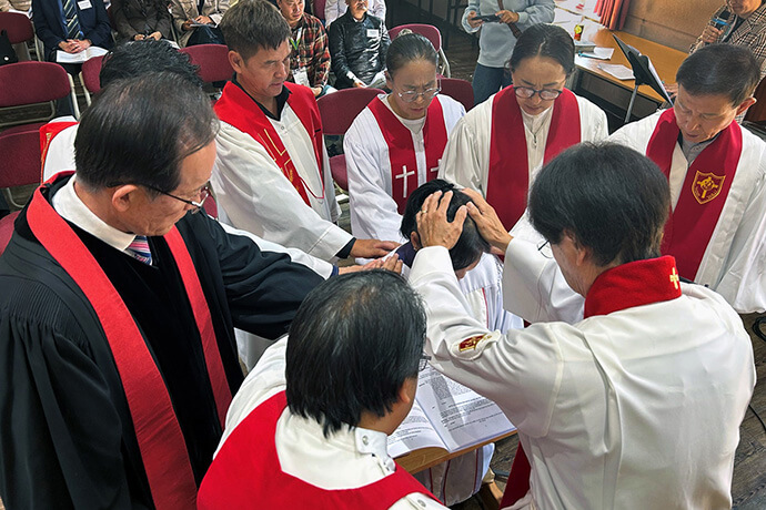 Bishop Jeremiah J. Park offers a prayer of blessing for the Rev. R. Jargaltsetseg during her ordination service at the United Methodist Mongolia Mission Initiative’s annual meeting in Ulaanbaatar, Mongolia, on Aug. 30. Photo by the Rev. Thomas E. Kim, UM News.