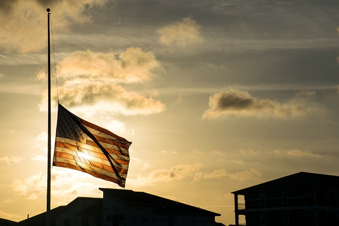 An American flag waves at half-staff in 2018 after the shooting at Marjory Stoneman Douglas High School in Parkland, Florida. Flags are standing at half-staff again after the Sept. 10 assassination of an activist on a university campus. United Methodist bishops are urging members to act as peacemakers to help put an end to the violence. Photo by Bryan Roschetzky, iStock. An American flag waves at half-staff in 2018 after the shooting at Marjory Stoneman Douglas High School in Parkland, Florida. Flags are standing at half-staff again after the Sept. 10 assassination of an activist on a university campus. United Methodist bishops are urging members to act as peacemakers to help put an end to the violence. Photo by Bryan Roschetzky, iStock.