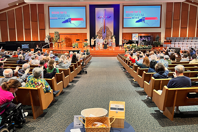 The Rev. Gina Anderson-Cloud of Floris United Methodist Church in Herndon, Va., prays over church members preparing for a Volunteers in Mission trip to help those affected by Hurricane Helene. Photo courtesy of Floris United Methodist Church.