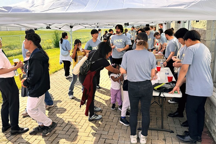 Families visit booths set up outside Chicago First Korean United Methodist Church in Wheeling, Ill., during the church’s Sept. 13 “Great Feast for Refugees and Neighbors.” The event marked the congregation’s 102nd anniversary and its commitment to supporting vulnerable members of the community. Families from refugee centers across Chicago participated in a day filled with worship, music, food, fellowship and practical support. Photo courtesy of Chicago First Korean United Methodist Church. Families visit booths set up outside Chicago First Korean United Methodist Church in Wheeling, Ill., during the church’s Sept. 13 “Great Feast for Refugees and Neighbors.” The event marked the congregation’s 102nd anniversary and its commitment to supporting vulnerable members of the community. Families from refugee centers across Chicago participated in a day filled with worship, music, food, fellowship and practical support. Photo courtesy of Chicago First Korean United Methodist Church.