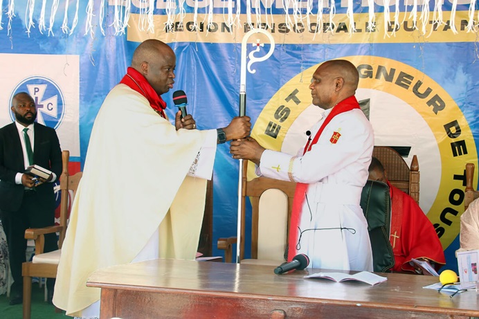 Bishop Mande Muyombo (left), president of the Africa Colleges of Bishops, presents the episcopal staff to Bishop Nelson Kalombo Ngoy during Ngoy’s installation as the first bishop of the new Tanganyika Episcopal Area on Sept. 14 in Kalemie, Congo. Photo by Chadrack Tambwe Londe, UM News. Bishop Mande Muyombo (left), president of the Africa Colleges of Bishops, presents the episcopal staff to Bishop Nelson Kalombo Ngoy during Ngoy’s installation as the first bishop of the new Tanganyika Episcopal Area on Sept. 14 in Kalemie, Congo. Photo by Chadrack Tambwe Londe, UM News.