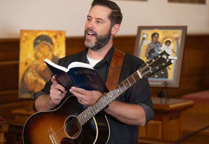 The Rev. Ryan Hebel helps lead opening worship for the 2025 United Methodist Church Deacons Gathering at the Upper Room Chapel in Nashville, Tenn. Hegel is a deacon who is now working with The Gathering, a United Methodist congregation in St. Louis, to plant a new church. Photo by Mike DuBose, UM News.