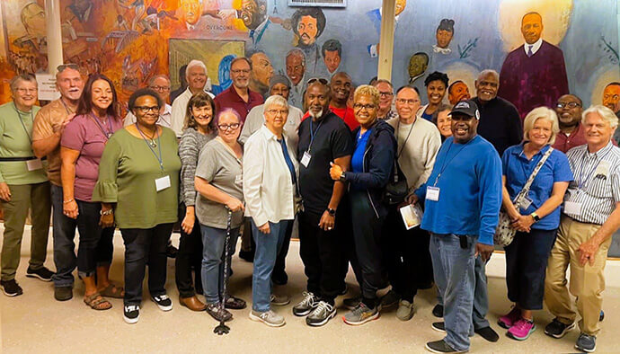 Members of the Western North Carolina Conference’s Blue Ridge District visit a mural in the basement of the Dexter Avenue Baptist Church in Montgomery, Ala., where the Rev. Martin Luther King Jr. first served as a pastor and led meetings to plan the historic Montgomery Bus Boycott. The district led two civil rights pilgrimages to Alabama for clergy and laity in 2022 and 2023. File photo courtesy of the Rev. Lisa Moore. 