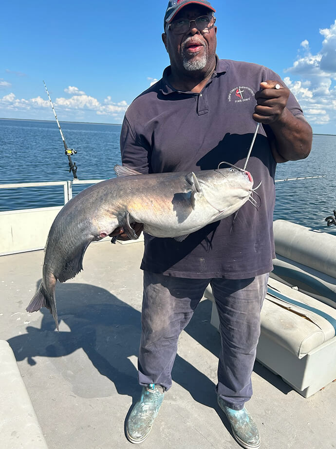 Bishop Frank Beard, an avid fisherman, stands with a catfish he recently caught in South Carolina. Photo courtesy of Bishop Frank Beard.