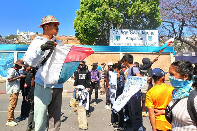 A young protester from Generation Z Madagascar holds a Malagasy flag during an Oct. 10 demonstration in downtown Antananarivo, Madagascar. What began as outrage over constant power and water outages has evolved into a nationwide movement denouncing corruption, poverty and social injustice. United Methodist Bishop João Sambo has called all church members to pray for peace and national reconciliation. Photo by Rakotoarivony Esdras, UM News.